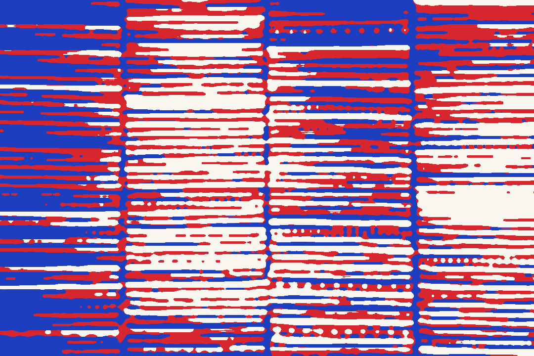 Stacked folds of patterned fabric in reds and stripes.