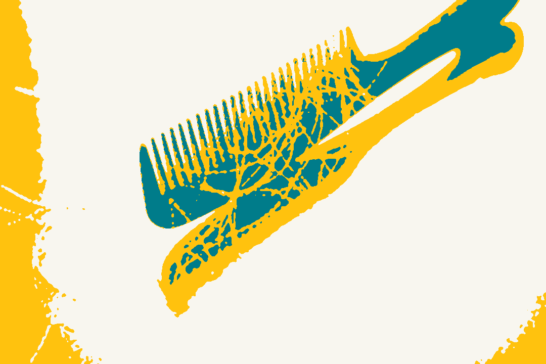 A black comb with loose strands of hair on it.