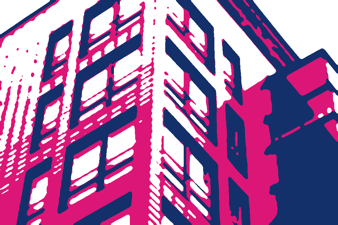 A tall red apartment building with rows of windows.
